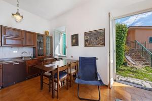 a kitchen with a table and chairs and a window at Bilo Costella in Bonassola +14 photos