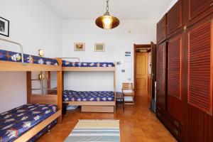 a bedroom with two bunk beds and a hallway at Bilo Costella in Bonassola