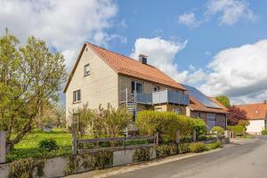 a house with a fence on the side of the road at Weserberglandblumen in Bad Pyrmont