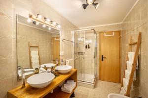 a bathroom with a sink and a shower at Mountain Residence Kasern Nr 1 in Predoi +21 photos