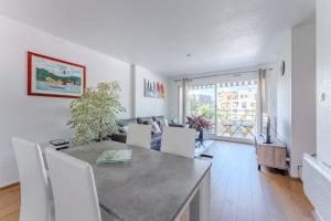 a kitchen and living room with a table and chairs at Petitbuch in La Teste-de-Buch