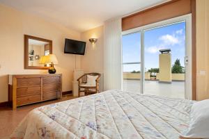 a bedroom with a bed and a large window at Vila Roser in L'Ametlla de Mar +35 photos
