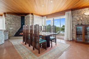 a dining room with a table and chairs and a fireplace at Vila Roser in L'Ametlla de Mar