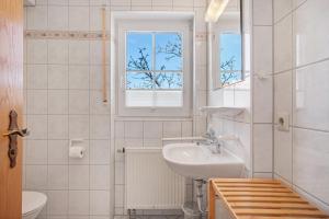 a white bathroom with a sink and a window at Obst- und Ferienhof Lehle in Immenstaad am Bodensee +196 photos