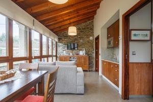 a kitchen and living room with a couch and a table at Camiño in Ordes