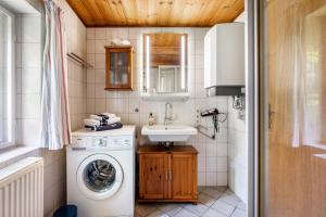 a small bathroom with a washing machine and a sink at Fewo Silke Dethlefsen in Pellworm +64 photos