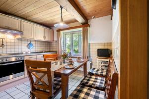 a kitchen with a table and chairs in a room at Fewo Silke Dethlefsen in Pellworm