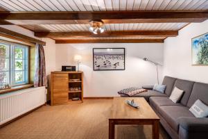 a living room with a couch and a table at Fewo Silke Dethlefsen in Pellworm