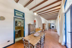 a dining room with a wooden table and chairs at Villa Blu La Cambusa in Castro di Lecce