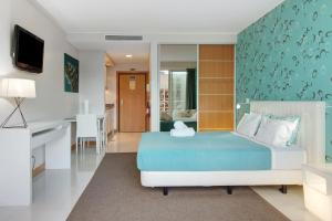a bedroom with a bed and a desk at Dfm Happy Days E - Funchal in Funchal
