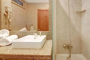 a bathroom with a white sink and a shower at Dfm Happy Days E - Funchal in Funchal