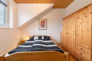 a bedroom with a bed and a wooden cabinet at Alte Stadtvilla in Neuwied