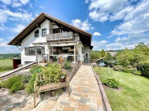 a white house with a porch and a patio at Landharmonie Knüll in Frielendorf