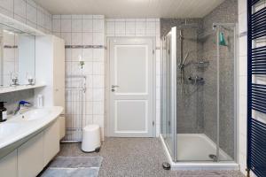 a bathroom with a shower and a sink and a tub at Landharmonie Knüll in Frielendorf +13 photos