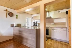 a kitchen with a large counter in a room at Ferienhaus em Biehl in Frankenhofen +26 photos