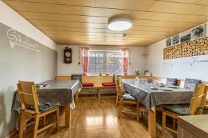 a dining room with two tables and chairs at Ferienhaus em Biehl in Frankenhofen