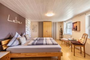 a bedroom with a large bed in a room at Ferienhaus em Biehl in Frankenhofen