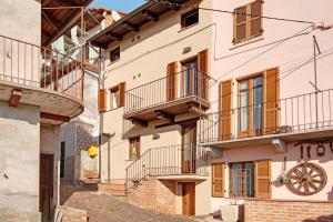 a building with balconies and stairs in a city at Vicolo 10 in Asti