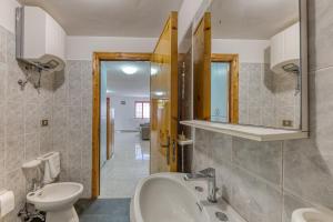 a bathroom with a sink toilet and a mirror at Pilella in Alliste +19 photos