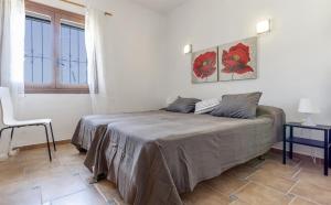 a bedroom with a bed and a chair and a window at Vistas a Moraira in Teulada