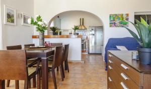 a kitchen and dining room with a table and chairs at Vistas a Moraira in Teulada