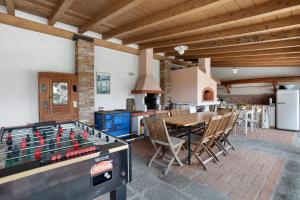 a kitchen and dining room with a table and a foos ball at La Vigna - Tra 5 terre e Versilia in Sarzana