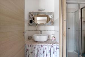 a bathroom with a sink and a mirror at La Vigna - Tra 5 terre e Versilia in Sarzana +20 photos