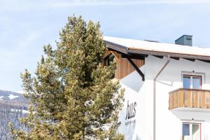a building with a tree in front of it at Hus Appartement - Nr. 4 in Valdaora +5 photos