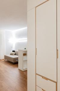 a living room with a glass door and a couch at Hus Appartement - Nr. 4 in Valdaora