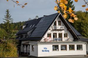 a house with solar panels on the roof at Villa Nordhang - Apartment 04 in Winterberg
