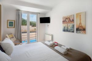 a bedroom with a white bed and a window at Praia Areia Branca in Lourinhã +18 photos