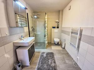 a bathroom with a sink and a toilet at Chalet Alpina by Interhome in Ovronnaz