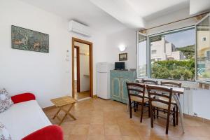 a living room with a table and chairs and a window at Agriturismo La Realidad in Finale Ligure