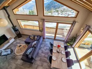 an overhead view of a living room with a couch and tables at Chalet Alpina by Interhome in Ovronnaz +40 photos