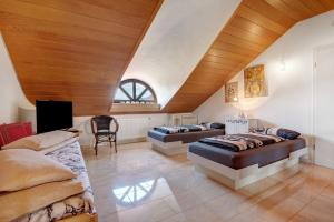 a bedroom with two beds and a wooden ceiling at Villa Galerie in Hohenwart