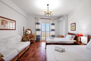 a living room with two beds and a couch at Quinta da Violeta in Loulé +29 photos