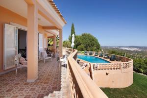a villa with a swimming pool and a patio at Quinta da Violeta in Loulé