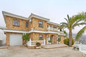 a house with a palm tree in front of it at Villa Soraida in Ítrabo