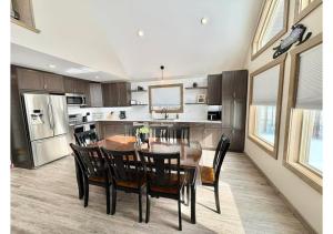 a kitchen with a dining room table and chairs at Sunny Peaks in Valemount