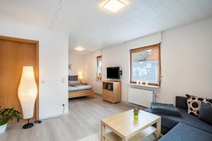 a living room with a couch and a table at Ferienwohnung Brigitte in Forbach