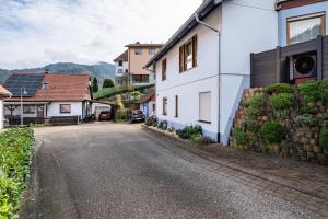 an empty street in a village with houses at Ferienwohnung Brigitte in Forbach