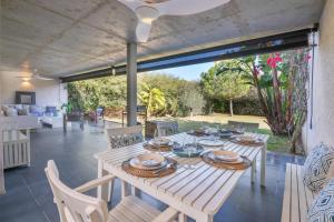 a wooden table and chairs on a patio at Villa Rompido in Cartaya