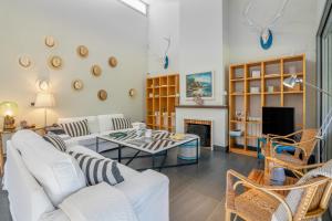 a living room with white furniture and a fireplace at Villa Rompido in Cartaya