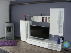 a white entertainment center with a flat screen tv at Ferienwohnung Schopper in Halblech