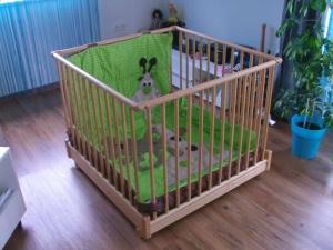 a crib with a stuffed animal in it at Ferienwohnung Schopper in Halblech