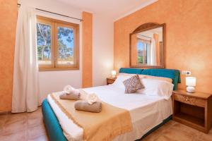 a bedroom with a bed with towels on it at Santa Eulalia in Can Picafort
