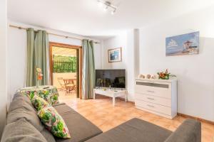 a living room with a couch and a table at Santa Eulalia in Can Picafort