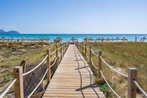 a wooden boardwalk leading to the beach at Santa Eulalia in Can Picafort