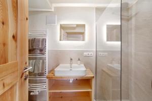a bathroom with a sink and a shower at Hauserhof in Lagundo +38 photos
