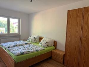 a small bedroom with a bed and a window at Casa Jo und Jo in Pfullendorf